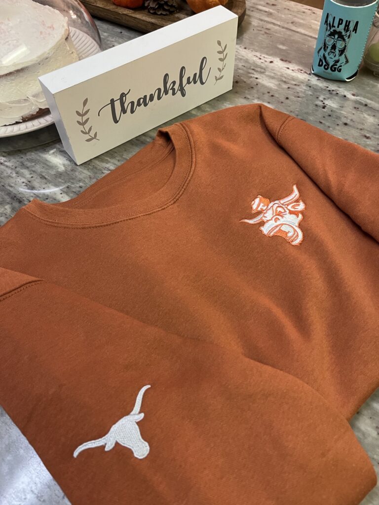 Burnt orange custom embroidered fleece sweater for local client in Austin TX
